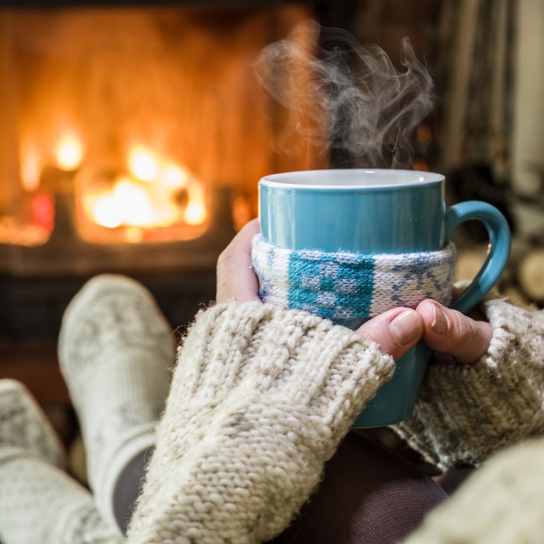 Cozy up to a fireplace with thick sweater.